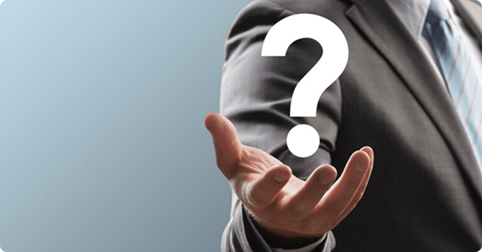 A man pointing to a question mark