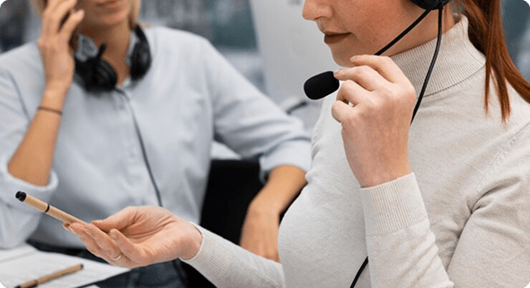 Woman holding pair of headphones